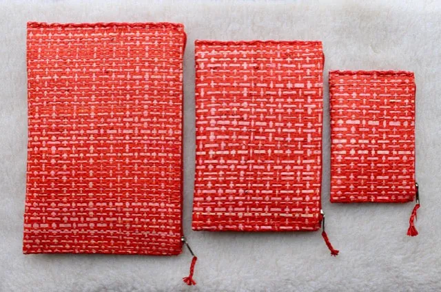 set of 3 hot pink and red raffia woven clutches with leather trim
