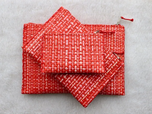 set of 3 hot pink and red raffia woven clutches with leather trim